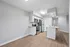 Modern kitchen with sleek stainless steel appliances, granite countertops, and elegant hardwood flooring.