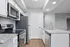 Modern kitchen with sleek granite countertops, stainless steel appliances, and ample cabinet space in an elegant apartment.