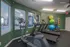 Modern fitness room with treadmills, elliptical, and vibrant exercise balls, offering a dynamic workout space.