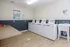 Modern laundry room with energy-efficient washers, spacious folding table, and a convenient utility sink.