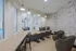 Chic communal space with modern decor, comfortable seating, and large windows overlooking a pool area.