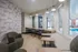 Stylish lounge with modern seating, wooden accents, and large windows offering a pool view, perfect for relaxation and social gatherings.