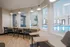 Bright and inviting workspace overlooking a luxurious indoor pool area, featuring modern seating and ample natural light.