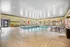 Inviting indoor pool area with stylish lounge chairs, vibrant decor, and ample natural light for a relaxing retreat.
