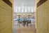 Inviting indoor pool area with elegant seating, surrounded by arched windows for natural light.