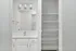 Sleek and modern bathroom vanity with ample shelving space and contemporary lighting fixtures, perfect for stylish storage.