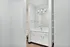 Modern bathroom with sleek white cabinetry, spacious vanity, and elegant lighting, offering a clean and inviting ambiance.