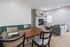 Charming living area with cozy fireplace, modern dining set, and sleek lounge chairs, ideal for relaxation and entertaining.