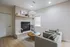 Inviting living room featuring a cozy fireplace, chic modern furniture, and an elegant decorative shelf.
