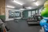 Modern fitness center with high-quality gym equipment, including treadmills, weights, and exercise balls, in a bright and spacious setting.