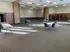Spacious multipurpose room with elegant brick accents, versatile seating options, and abundant natural light.
