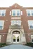 Charming historic brick building with large windows and grand entrance, perfect for residential conversion.