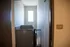 Bright hallway with modern lift and ample natural light from large window.