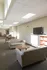 Bright lounge area with comfortable beige sofas, modern decor, and ample natural light from large windows, offering a cozy and inviting atmosphere.