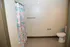 Inviting bathroom with floral patterned shower curtain, neutral walls, and modern fixtures for a refreshing ambiance.