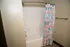 Modern bathroom with a sleek bathtub and vibrant floral shower curtain featuring calming colors.