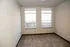 Bright bedroom with plush carpeting and large windows offering stunning natural light.