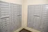 Modern and secure apartment mailroom with organized metal mailboxes and outgoing mail slots.