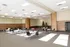 Spacious community hall with modern lighting, festive Christmas decor, and flexible seating arrangements perfect for events and gatherings.
