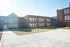 Modern educational building with sleek design, featuring large windows and a spacious walkway.
