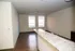 Bright and airy living space with polished wood floors and large windows offering ample natural light.