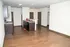 Modern apartment kitchen with sleek cabinets, spacious countertops, and elegant wooden flooring.