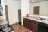 Modern kitchen with elegant granite countertops, dark wood cabinetry, and sleek stainless steel appliances.