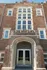 Charming vintage brick building with grand arched entrance and elegant windows, perfect for modern urban living.