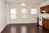 Bright and inviting kitchen with elegant wooden cabinetry, modern appliances, and sleek hardwood flooring, perfect for culinary enthusiasts.