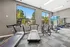 Modern gym facility with state-of-the-art treadmills and elliptical machines, featuring large windows with scenic views.