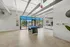 Spacious game room with modern pool table, chic decor, and large windows opening to a scenic outdoor view.
