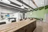 Modern communal space featuring a sleek, granite-topped kitchen island, stylish seating area, and a pool table under contemporary lighting.