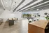 Contemporary communal space with a modern kitchen, stylish seating area, and vibrant recreational zone, featuring floor-to-ceiling windows and elegant lighting.