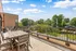 Expansive rooftop terrace with modern seating and scenic views, perfect for outdoor dining and relaxation.