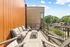 Charming rooftop patio with cozy seating and stunning neighborhood views, perfect for relaxation and entertaining.