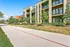 Modern apartment complex with spacious balconies and lush greenery, ideal for urban living.