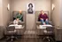 Chic pedicure spa room with two stylish seating areas and a classic black-and-white portrait, perfect for relaxation and socializing.