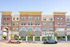 Charming urban building with elegant brick facade and large arched windows, highlighting a trendy beauty bar on the ground floor.