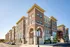 Contemporary brick apartment complex with elegant arches and large windows, offering modern living in a vibrant neighborhood.