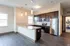 Modern kitchen with sleek stainless steel appliances, dark wood cabinetry, and elegant pendant lighting.