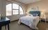 Bright bedroom with a stunning arched window view, stylish decor, and a cozy, inviting atmosphere.