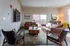 Inviting modern living room with stylish leather couches, elegant wooden coffee table, and vibrant decor, perfect for relaxation and entertainment.