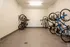 Spacious indoor bike storage room with modern wall-mounted racks offering secure and organized bicycle parking.