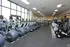 Modern fitness center featuring state-of-the-art cardio machines, treadmills, and exercise bikes in a spacious, well-lit environment.