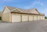 Charming row of tan garages with classic design, perfect for convenient and secure parking options.