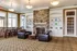 Inviting living room with elegant stone fireplace, plush leather sofas, and a chic dining area, perfect for relaxation and entertaining.