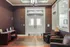 Elegant apartment lobby with modern lighting, cozy seating, and rich textured wallpaper.