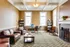 Elegant reading room with cozy leather seating, built-in bookshelves, and a charming fireplace, perfect for relaxation and productivity.