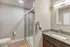Modern bathroom featuring sleek glass shower, elegant marble countertop, and bright lighting for a stylish touch.