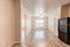 Bright and airy apartment interior with sleek hardwood flooring, modern appliances, and ample natural light.